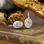 Load image into Gallery viewer, Matte Bezel Oval Cut Lab Diamond Dangle Earrings with Lab Blue Sapphire Hidden Halo
