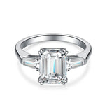 Load image into Gallery viewer, 3 Ct Emerald Cut Lab Diamond Three-Stone Engagement Ring with two Tapered Baguette - LGG Jewelry
