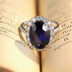 Lade Bild in die Galerieansicht, 8.5 Ct Oval Cut Lab Blue Sapphire Halo Engagement Ring - LGG Jewelry