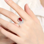 Lade Bild in die Galerieansicht, Split Shank Crown 2.7 Ct Pear Lab Ruby Half Pave Halo Engagement Ring - LGG Jewelry